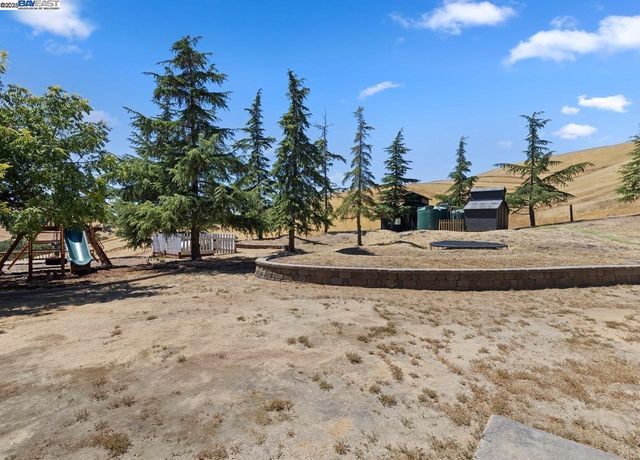 a swimming pool with trees in the background