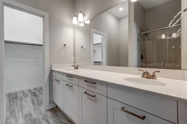 a bathroom with a double vanity sink and a mirror