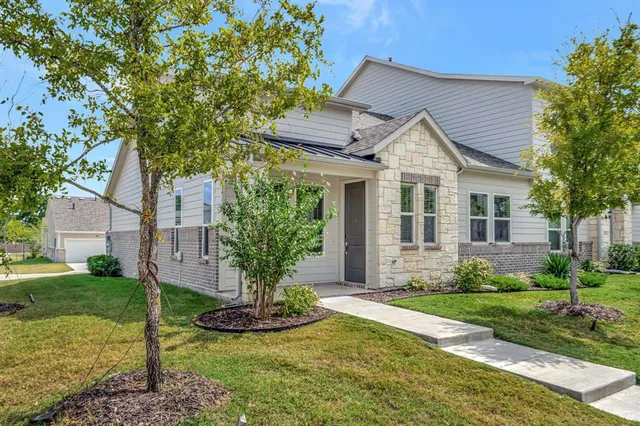 a front view of a house with a yard and porch