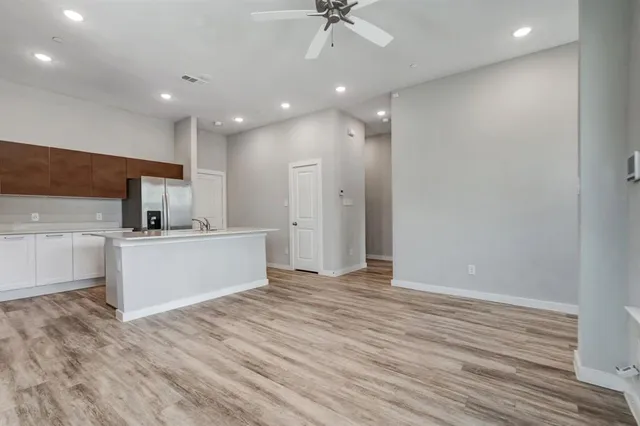 a view of kitchen with cabinets and wooden floor