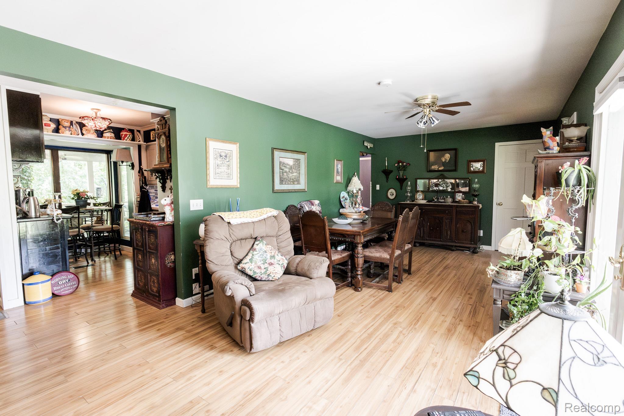 8197 Irish Road Millington, MI 48746 - Photo 17 of 38 Spacious common area featuring wood-finish flooring, a ceiling fan, and painted walls