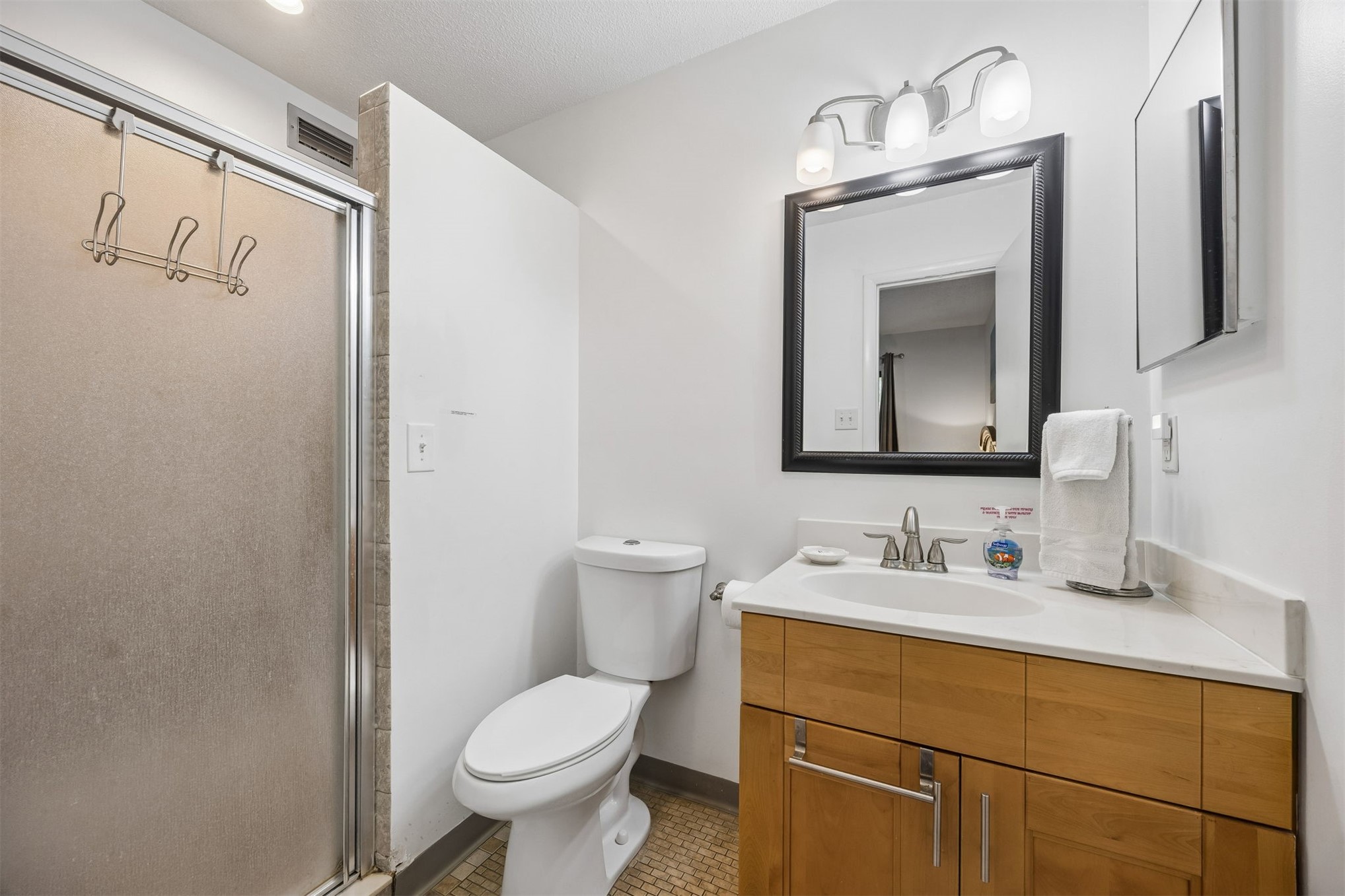 2328 Sadler Road, Unit 1C Fernandina Beach, FL 32034 - Photo 21 of 49 a bathroom with a toilet sink and mirror