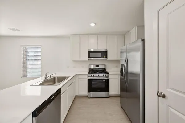 a kitchen with a sink stainless steel appliances and cabinets