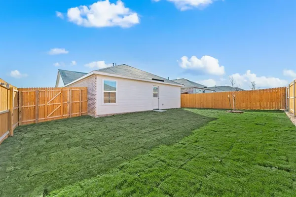 a backyard of a house with table and chairs