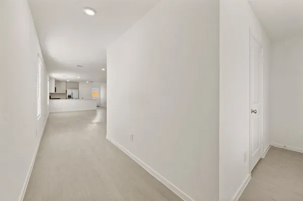 a view of a hallway with a kitchen