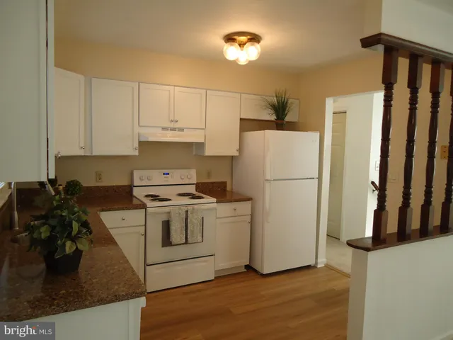 a kitchen with a refrigerator and a stove