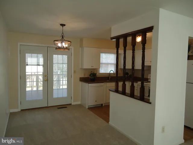 a view of a kitchen and a window in an empty room