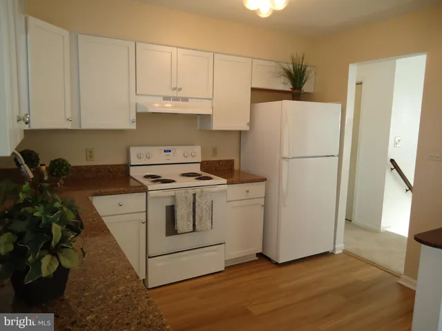 a white refrigerator freezer sitting inside of a kitchen