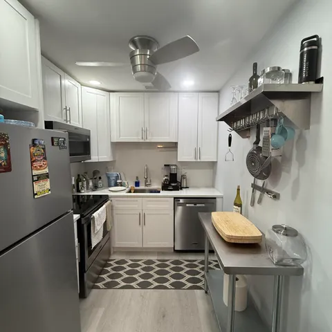 a kitchen with a sink a stove and cabinets