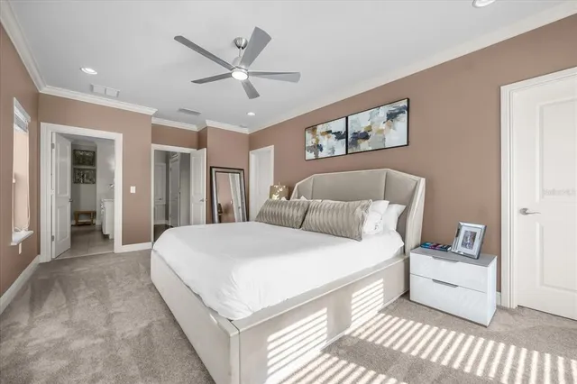 a spacious bedroom with a bed and a ceiling fan