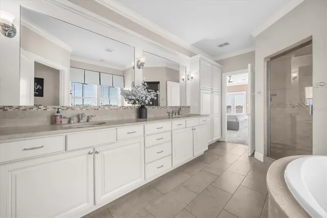 a spacious bathroom with a granite countertop sink mirror and a