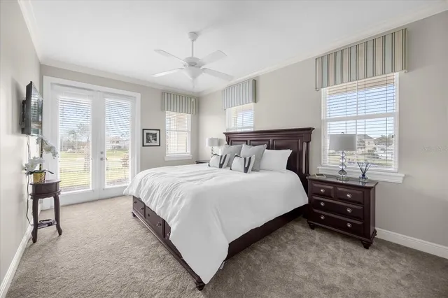 a bedroom with a bed and a large window