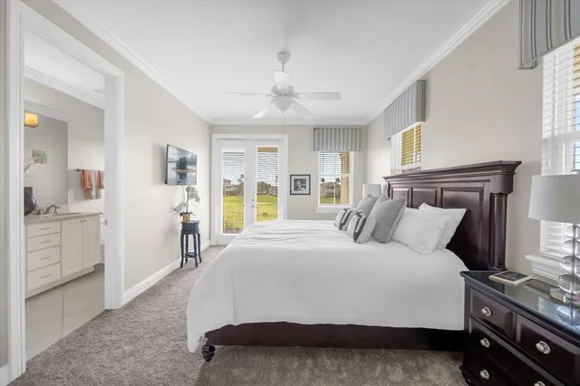 a bedroom with a large bed and a chandelier