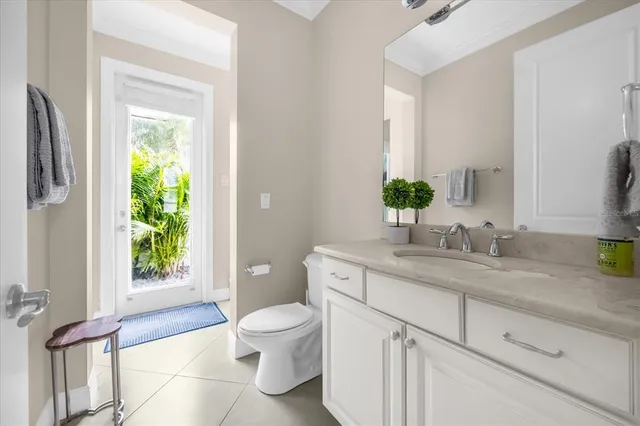 a bathroom with a granite countertop toilet sink and mirror