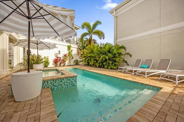 a view of a swimming pool with chair and tables