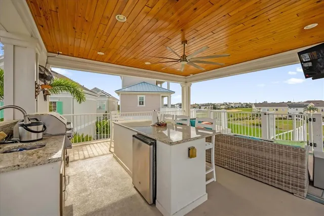 a view of a patio with a table chairs stove and a sink