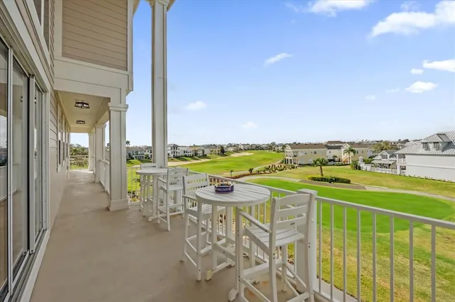 a view of a balcony with table and chairs