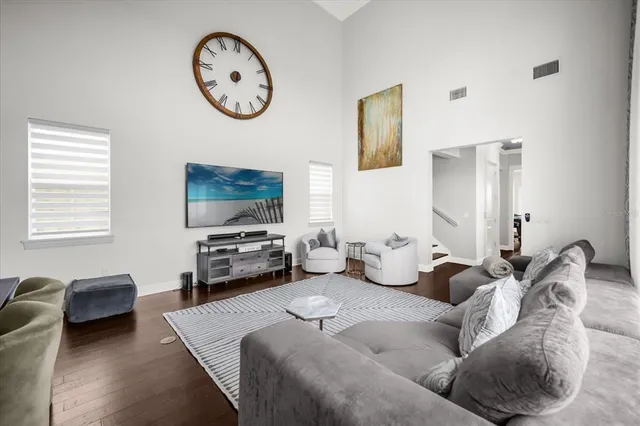 a living room with furniture a large window and a flat screen tv