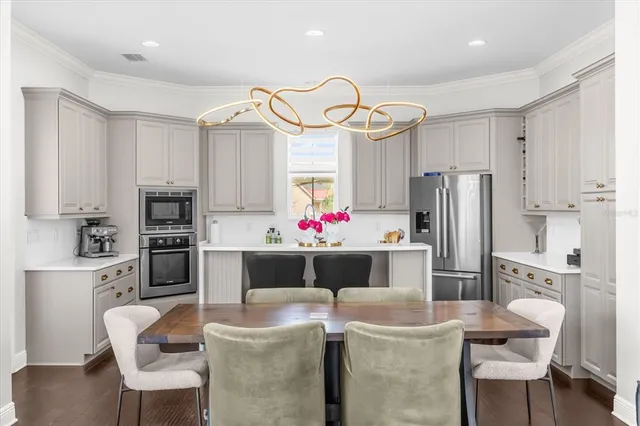 a living room with stainless steel appliances kitchen island granite countertop furniture and a kitchen view