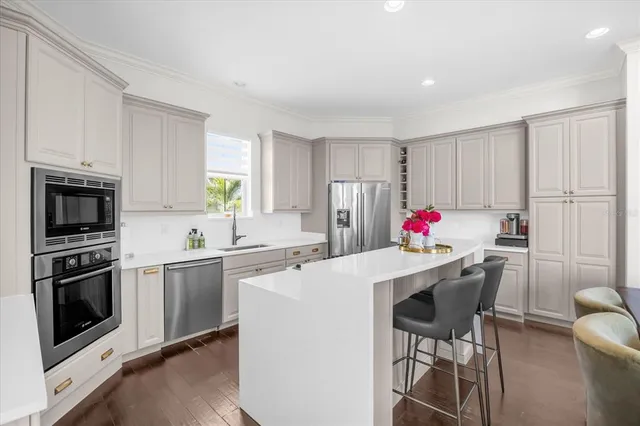 a kitchen that has a stove a table and chairs in it