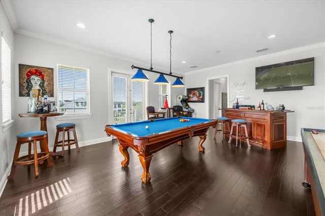 a living room with furniture a flat screen tv and kitchen view