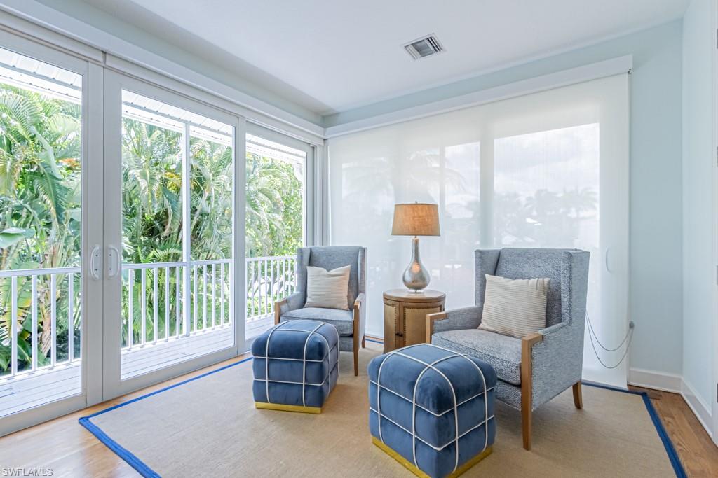 877 7th Street South Naples, FL 34102 - Photo 11 of 25 a living room with furniture and a large window