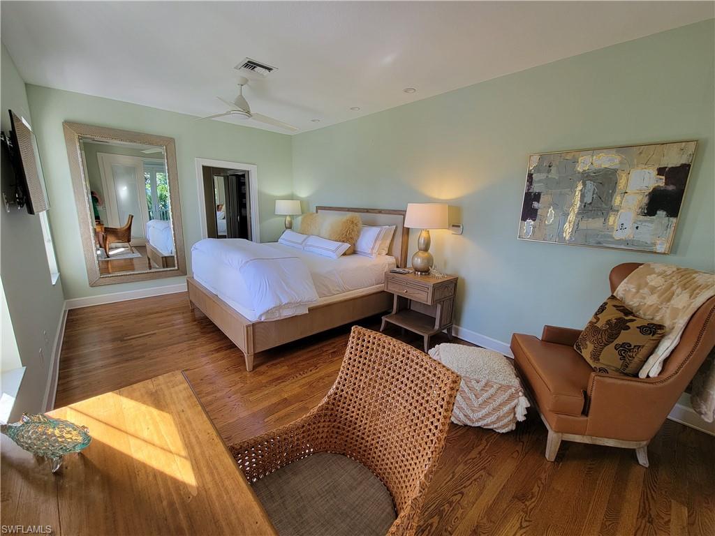 877 7th Street South Naples, FL 34102 - Photo 12 of 25 a bedroom with furniture and wooden floor