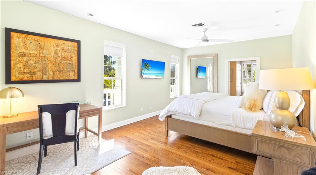 877 7th Street South Naples, FL 34102 - Photo 13 of 45 Bedroom with light wood-style floors, multiple windows, and ceiling fan