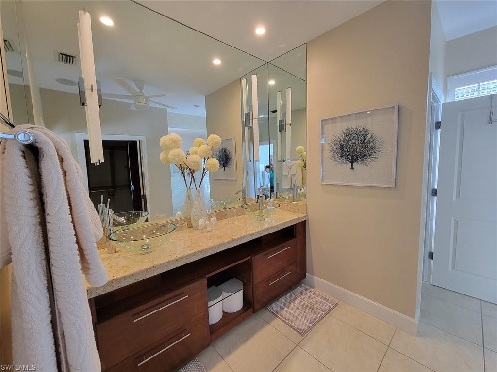 877 7th Street South Naples, FL 34102 - Photo 15 of 25 a view of kitchen with stainless steel appliances granite countertop cabinets and fireplace