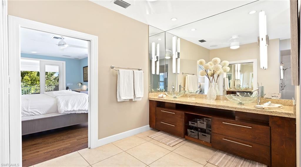877 7th Street South Naples, FL 34102 - Photo 16 of 45 Ensuite bathroom featuring double vanity, light tile patterned floors, and recessed lighting