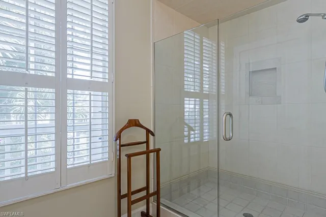 a bathroom with a shower and a window