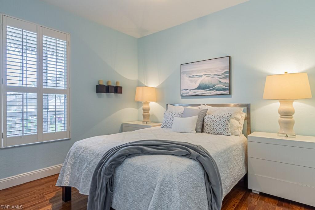 877 7th Street South Naples, FL 34102 - Photo 17 of 25 a bedroom with bed a lamp and a window