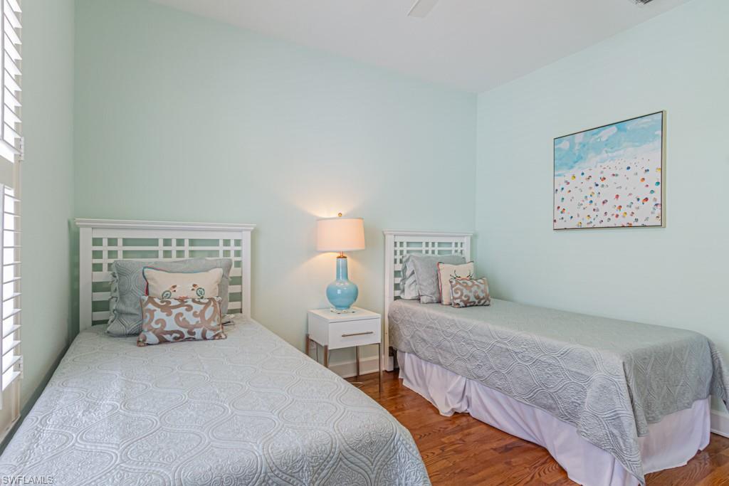 877 7th Street South Naples, FL 34102 - Photo 19 of 25 a bedroom with two beds and white walls
