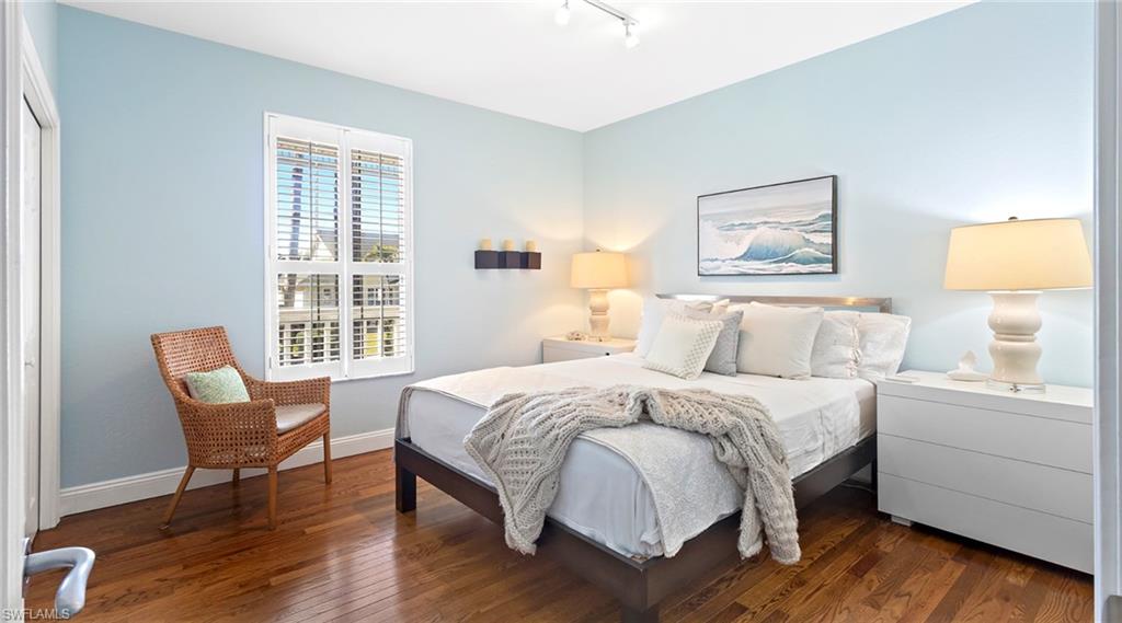 877 7th Street South Naples, FL 34102 - Photo 20 of 45 Bedroom featuring dark wood finished floors and rail lighting