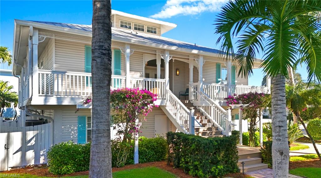 877 7th Street South Naples, FL 34102 - Photo 2 of 45 View of front facade with a metal roof and covered porch