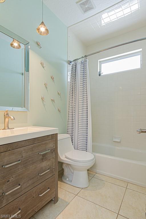 877 7th Street South Naples, FL 34102 - Photo 21 of 25 a bathroom with a granite countertop sink a toilet and shower