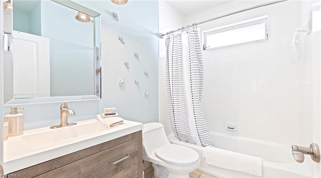 877 7th Street South Naples, FL 34102 - Photo 21 of 45 Bathroom with vanity and shower / bath combination with curtain