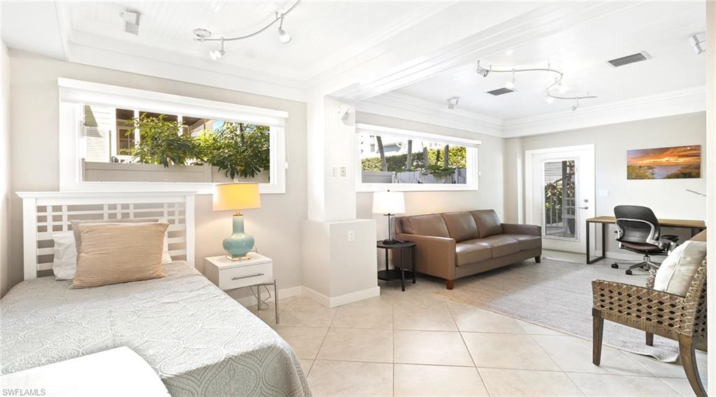 877 7th Street South Naples, FL 34102 - Photo 23 of 45 Bedroom featuring an office area, access to exterior, rail lighting, and light tile patterned floors