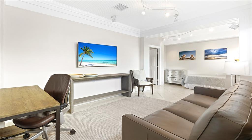 877 7th Street South Naples, FL 34102 - Photo 24 of 45 Office space with light tile patterned floors, crown molding, and rail lighting