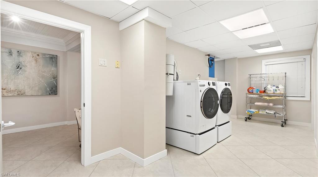 877 7th Street South Naples, FL 34102 - Photo 25 of 45 Laundry area featuring independent washer and dryer, light tile patterned floors, and a drop ceiling