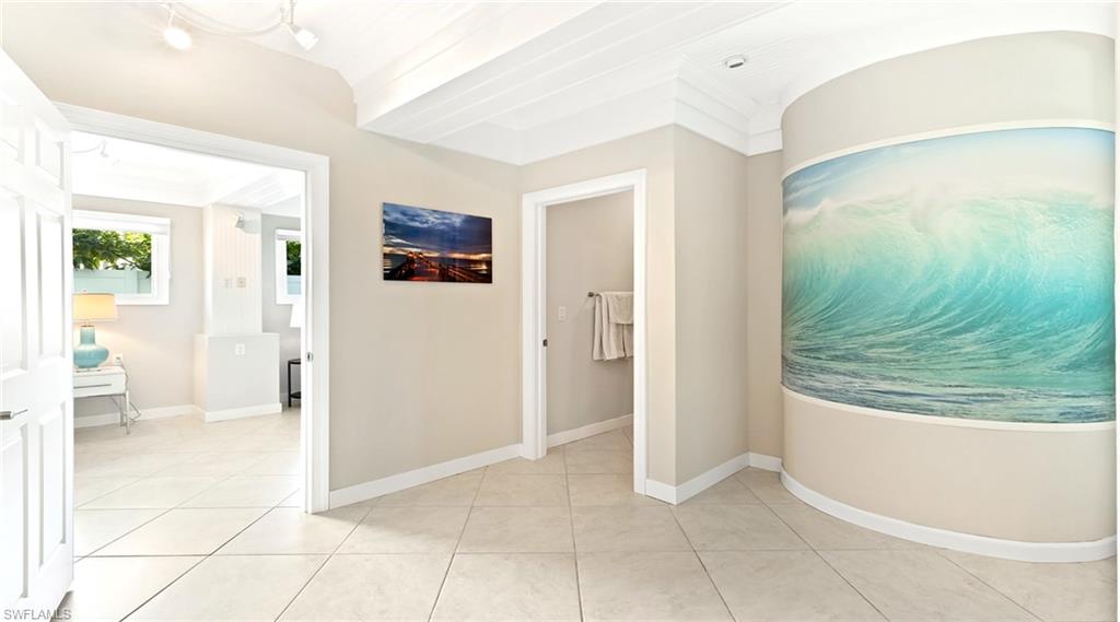 877 7th Street South Naples, FL 34102 - Photo 28 of 45 Corridor featuring crown molding and light tile patterned flooring