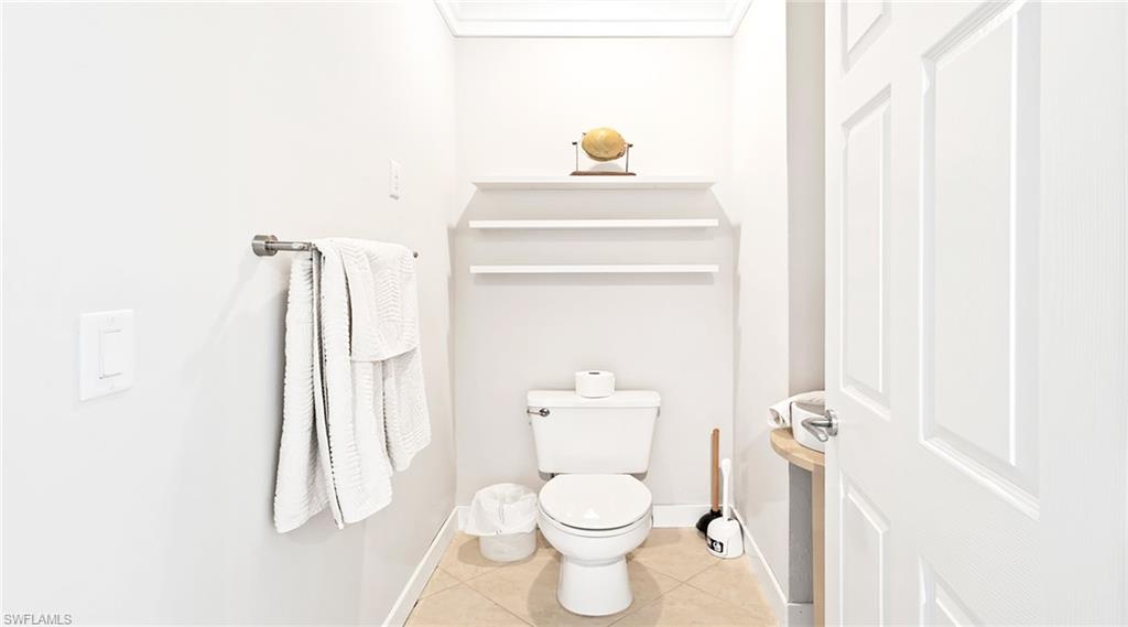 877 7th Street South Naples, FL 34102 - Photo 29 of 45 Bathroom with toilet and light tile patterned floors