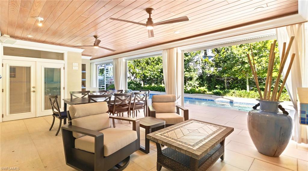 877 7th Street South Naples, FL 34102 - Photo 30 of 45 View of patio featuring an outdoor pool, ceiling fan, an outdoor hangout area, and french doors