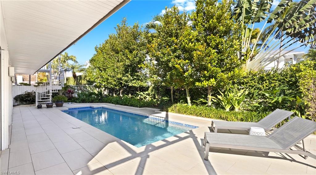 877 7th Street South Naples, FL 34102 - Photo 34 of 45 Outdoor pool with a patio and a fenced backyard