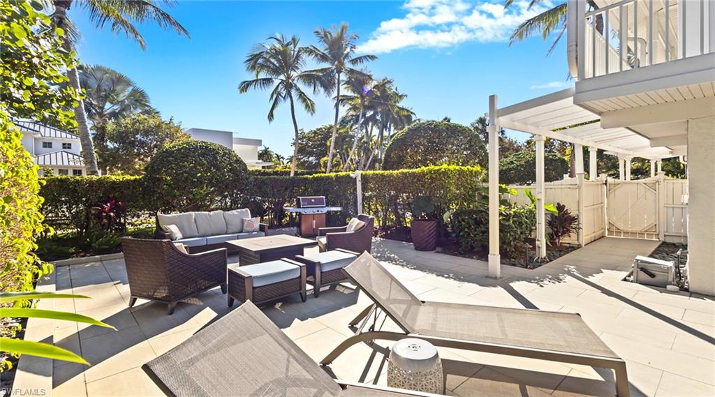877 7th Street South Naples, FL 34102 - Photo 38 of 45 Patio / terrace with an outdoor living space, a patio, a fenced backyard, and a grill