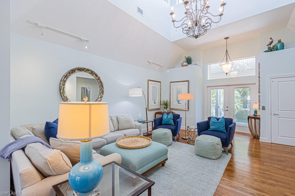 877 7th Street South Naples, FL 34102 - Photo 6 of 25 a living room with furniture chandelier and a table