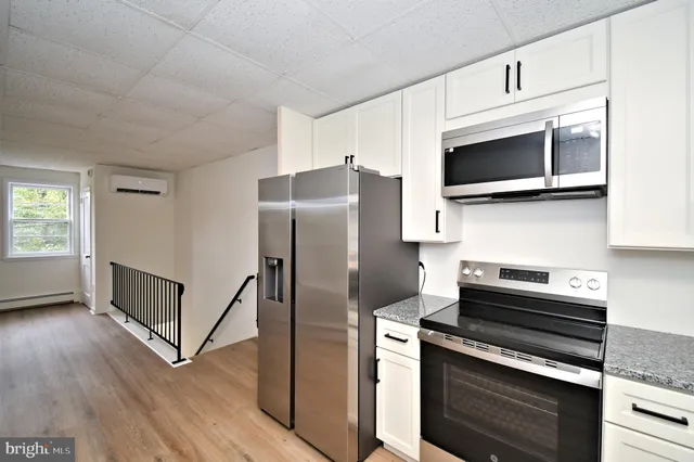 a kitchen with cabinets and stainless steel appliances