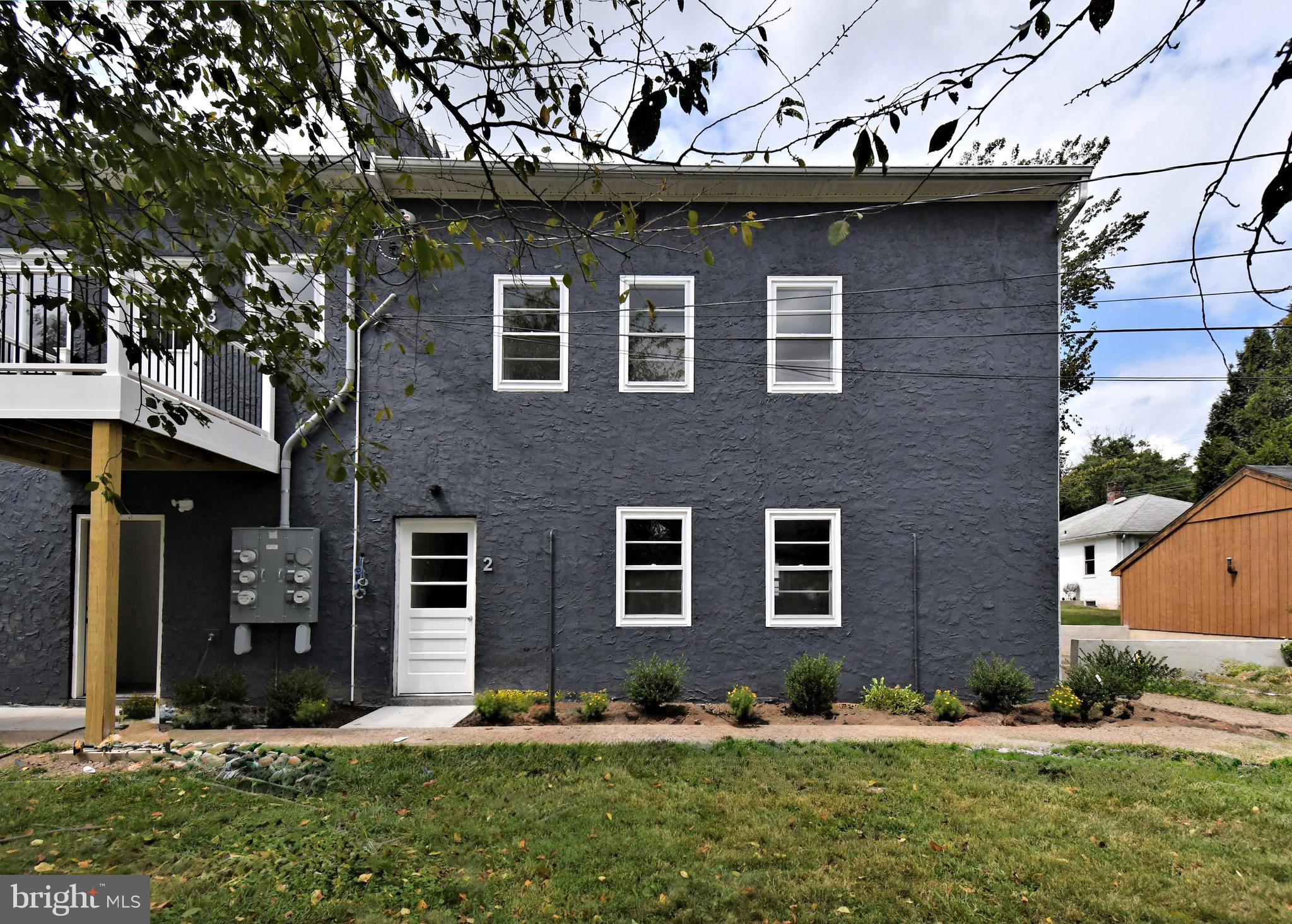 4776 Old Easton Road, Unit 2 Doylestown, PA 18902 - Photo 17 of 25 a front view of a house with a yard