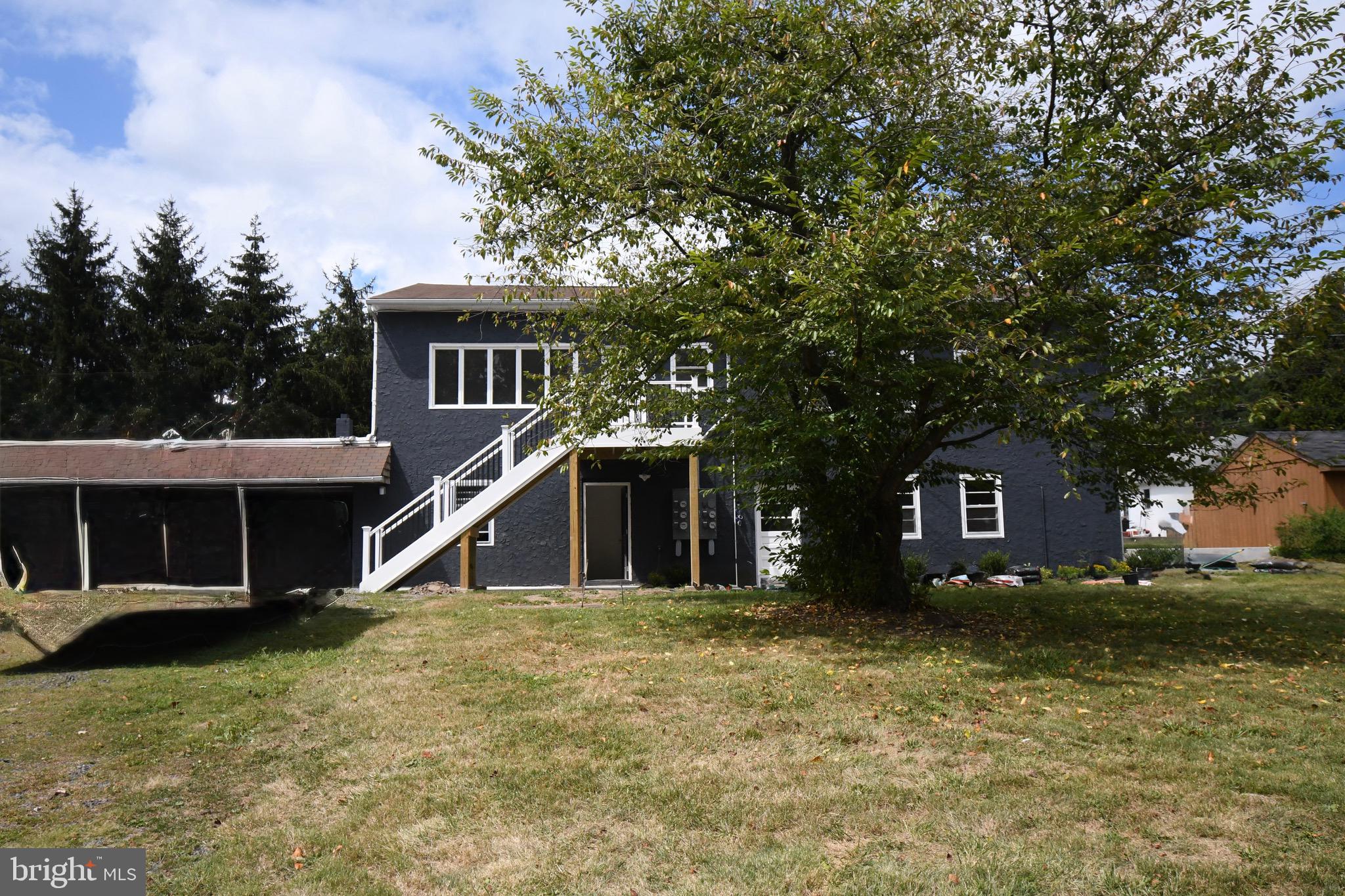 4776 Old Easton Road, Unit 2 Doylestown, PA 18902 - Photo 19 of 25 a front view of a house with a yard
