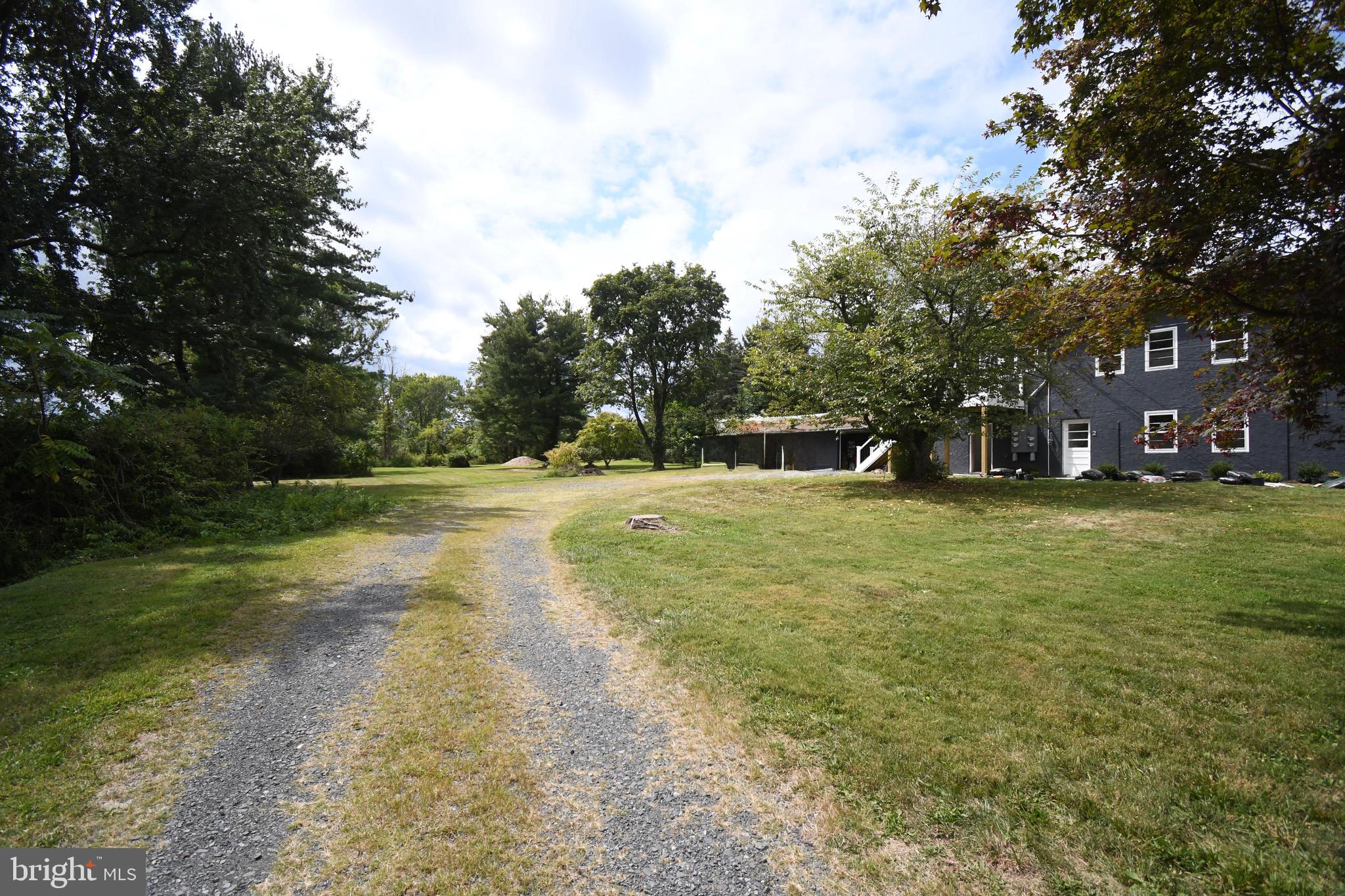 4776 Old Easton Road, Unit 2 Doylestown, PA 18902 - Photo 24 of 25 a view of yard with swimming pool and trees